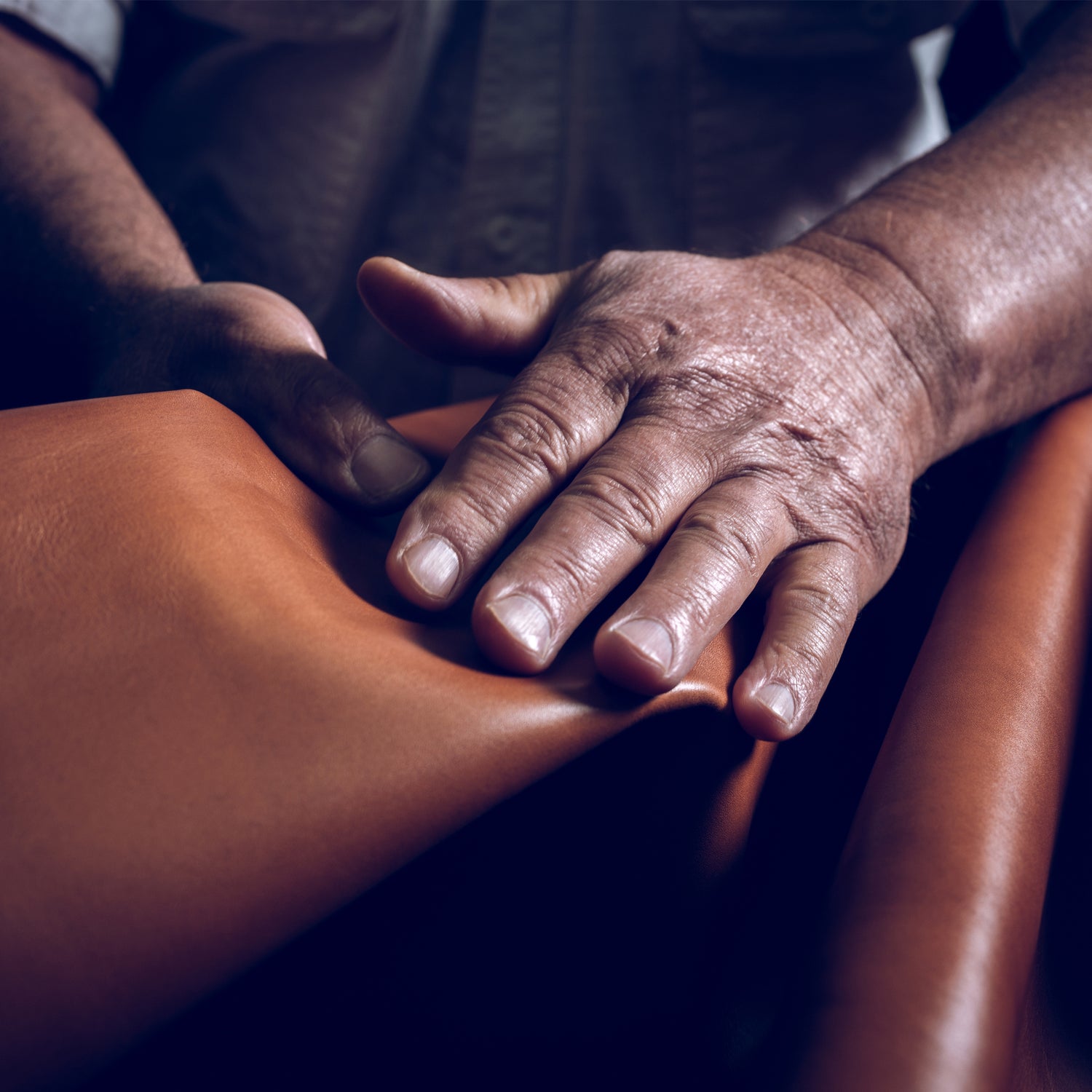 close up of a man handling leather material