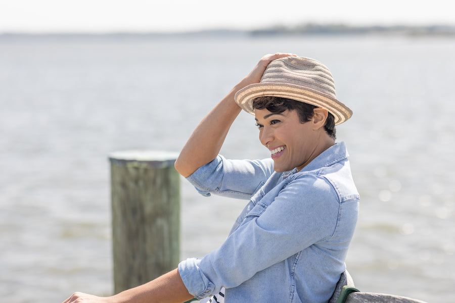 Woman on pier with hat