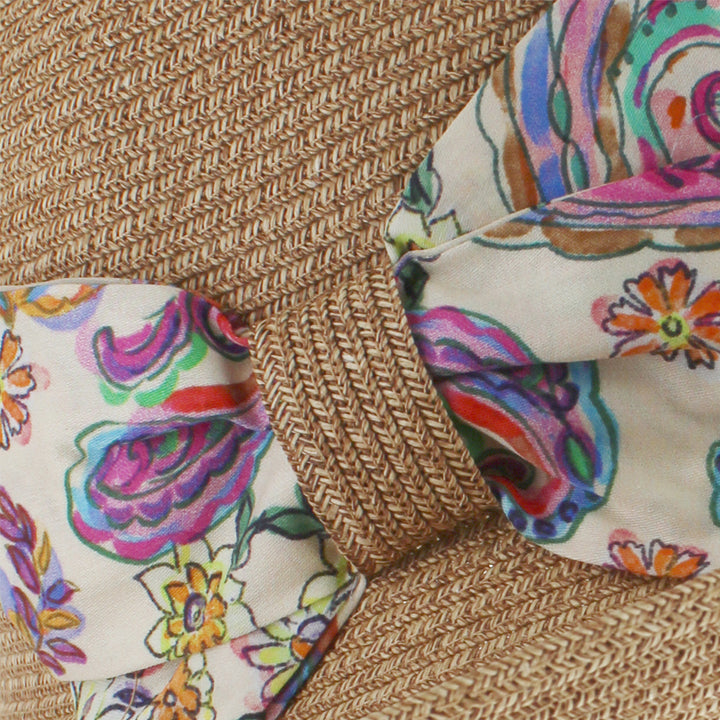 Natural cloche hat with floral bow designed for casual and beach styling