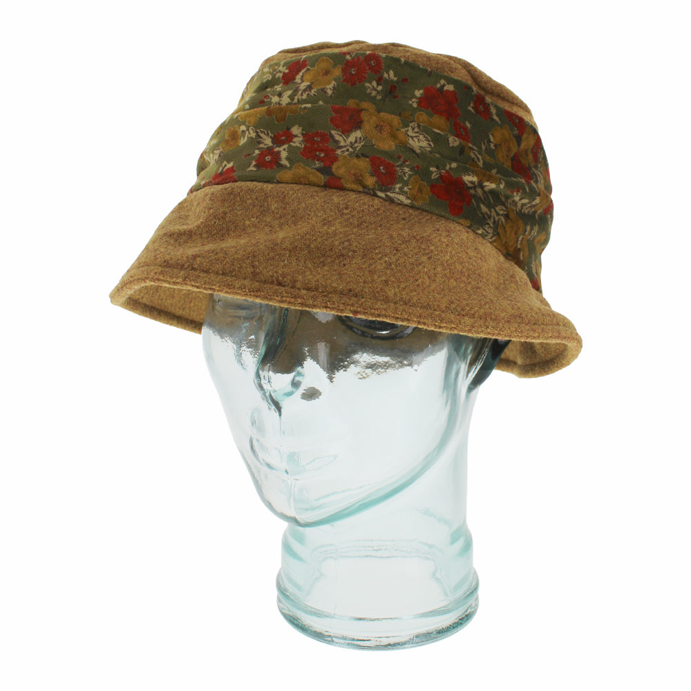 Close-up of Belfry Cassio gold hat showing detailed velvet floral band and wool finish