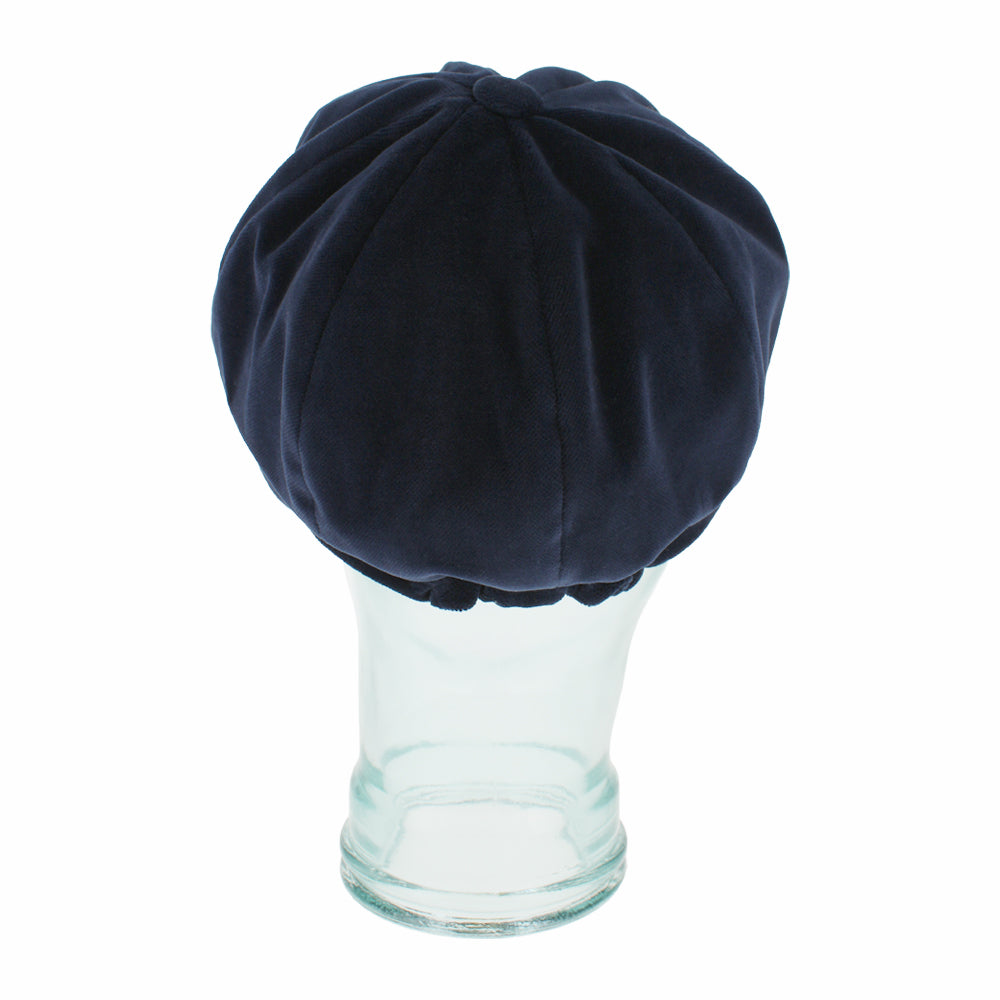 Top view of Belfry Dania navy mod cap with classic paneling and rich velvet look