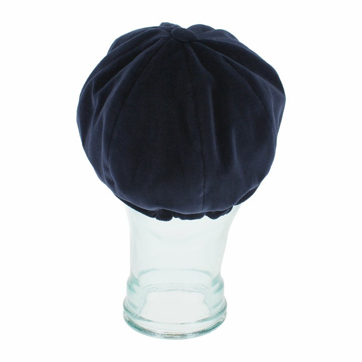 Top view of Belfry Dania navy mod cap with classic paneling and rich velvet look