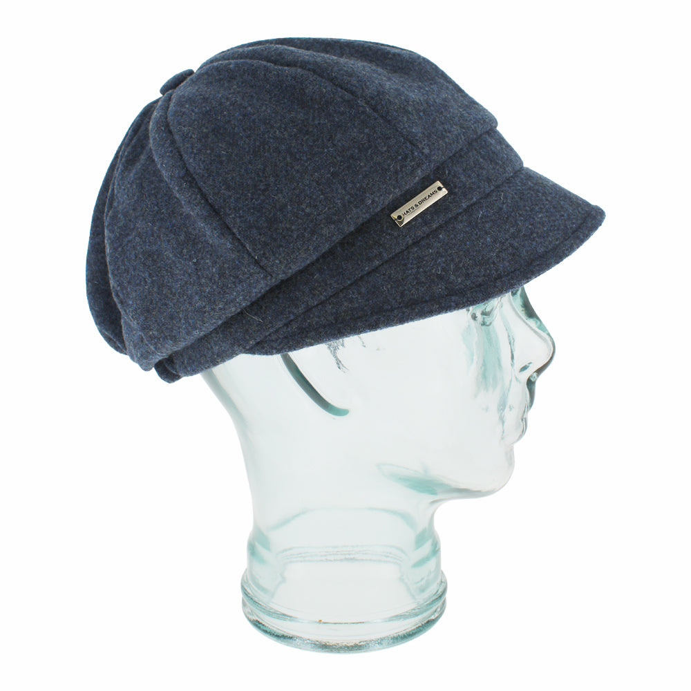 Side view of Belfry Edda blue wool mod cap showing soft texture and button top