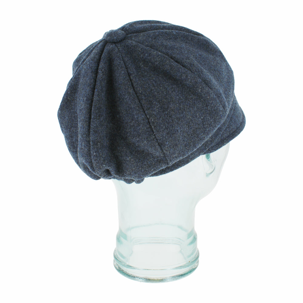 Angled shot of Edda blue Shetland wool cap with timeless 8-panel silhouette