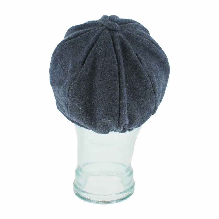 Top view of Belfry Edda blue mod cap highlighting its signature button and panels