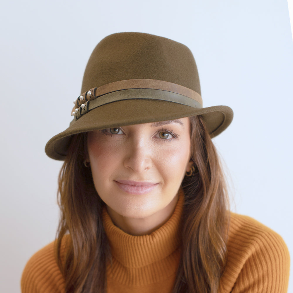 woman wearing olive asymmetrical trilby with double faux leather band belfry elda