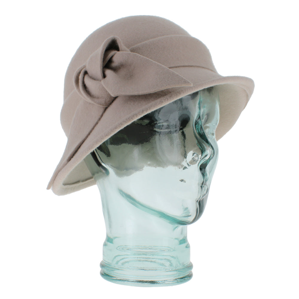 Belfry Fleur alabaster asymmetrical cloche hat crafted from 100% wool with a self-fabric band, finished with a hand-knotted bow and tails, a refined fall and winter wardrobe piece