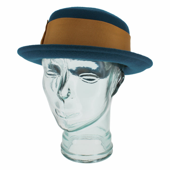 Top view of the Belfry Gardiner boater hat in teal blue wool with gold bow and grosgrain band, an elegant cold-weather accessory for chic autumn and winter women’s fashion