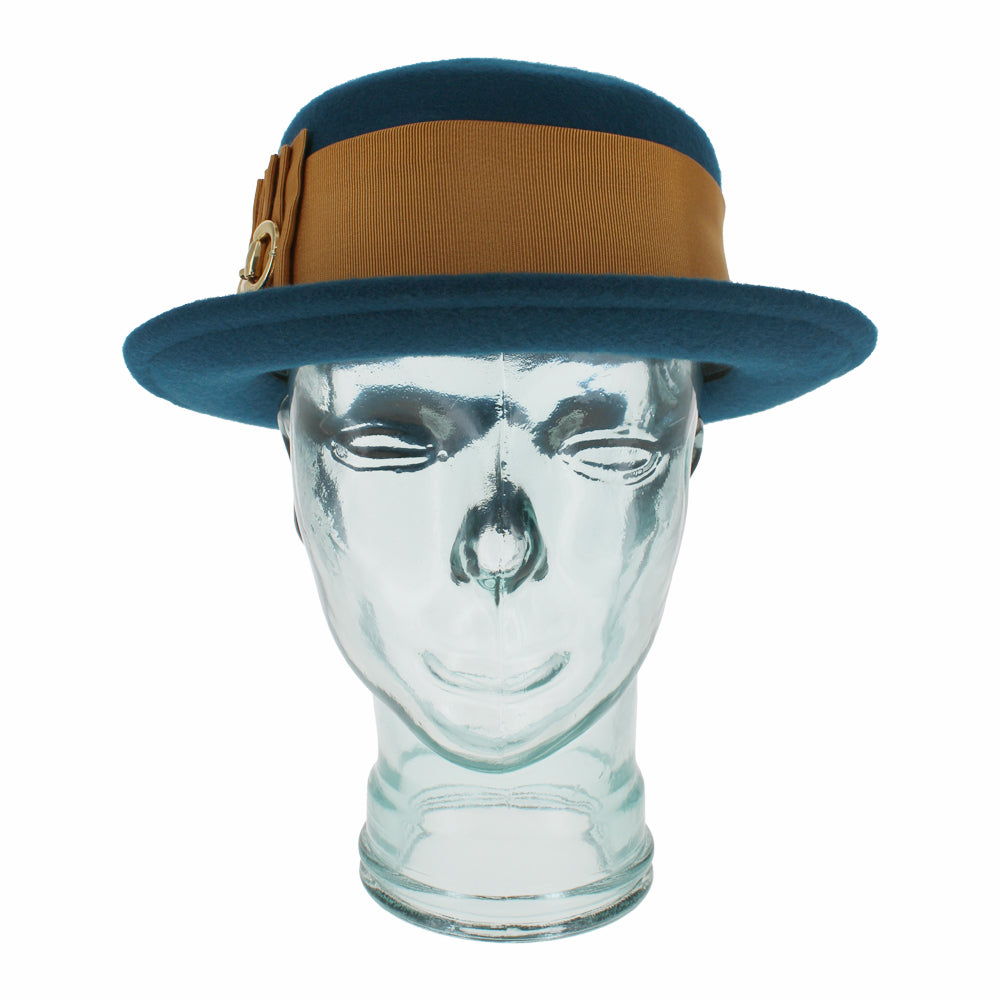 Belfry Gardiner teal wool boater hat featuring a wide grosgrain band, gold bow with links, and semi-packable structure, a striking women’s piece for fall and winter style