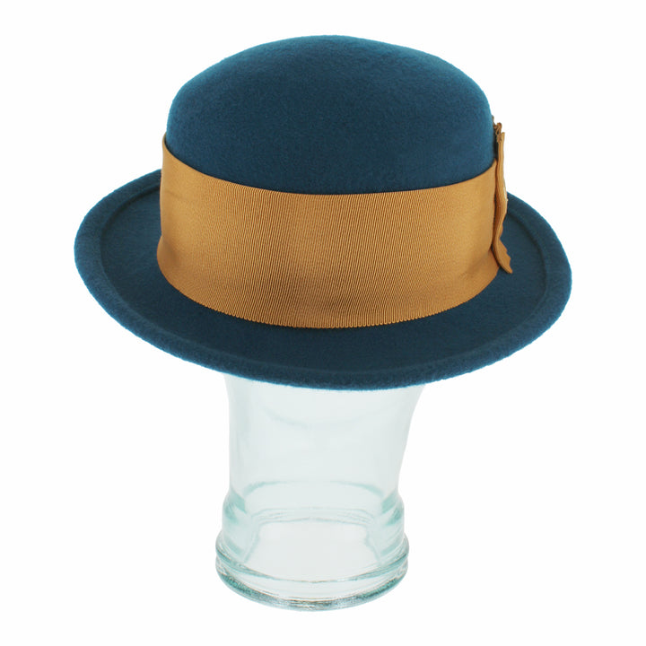 Side profile of the Belfry Gardiner teal boater hat crafted in wool with wide grosgrain band and golden bow, a refined seasonal accessory for stylish fall and winter outfits