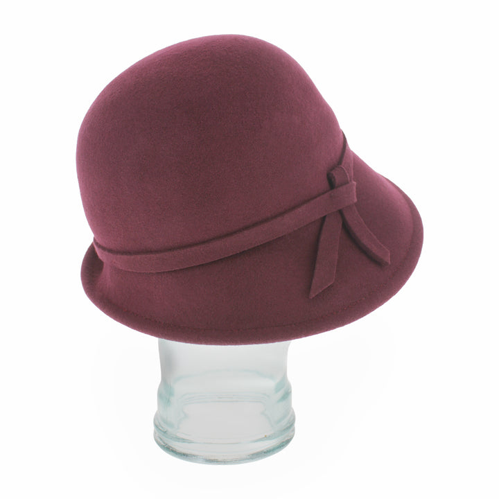 Side profile of the Belfry Harriet burgundy cloche hat in wool, designed with a simple asymmetrical brim, a chic and practical accessory for autumn and winter dressing