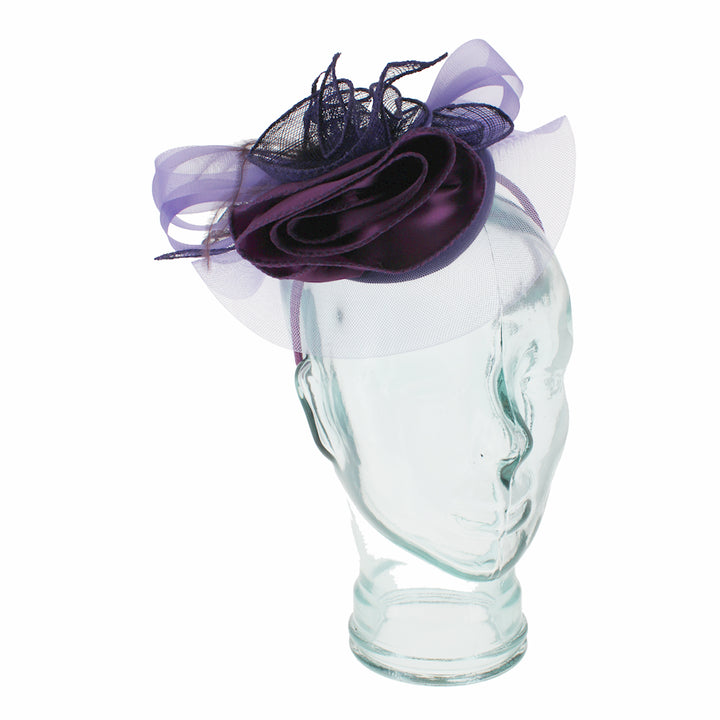 Purple headband fascinator with satin flower and feather detail for elegant formal styling