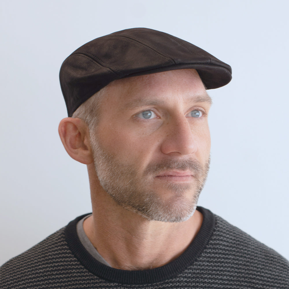 man wearing four panel leather cap belfry narciso black