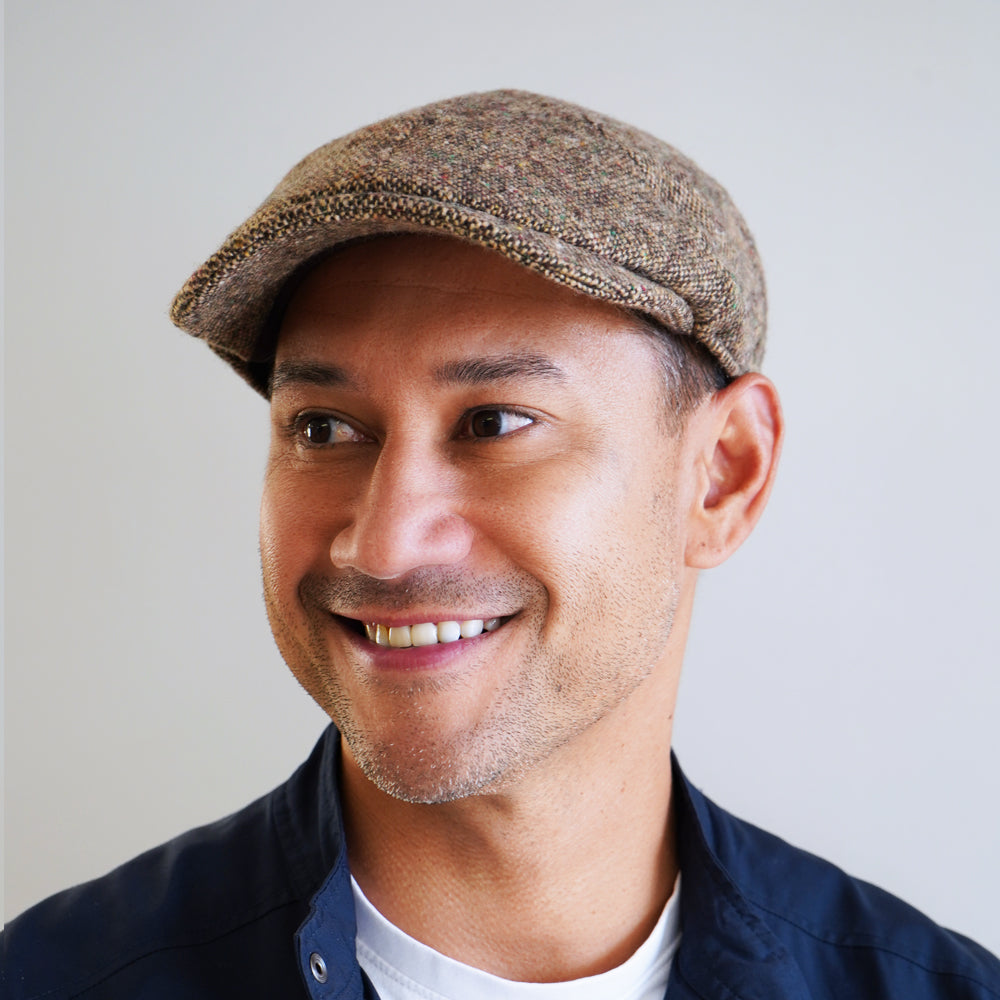 Brown Donegal tweed newsboy cap with slim 6 panel design and nailhead pattern by Wigens